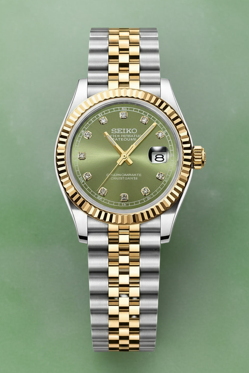 A Seiko two-tone wristwatch with a silver and gold-tone metal bracelet, a fluted gold-tone bezel, and a green dial with diamond hour markers.