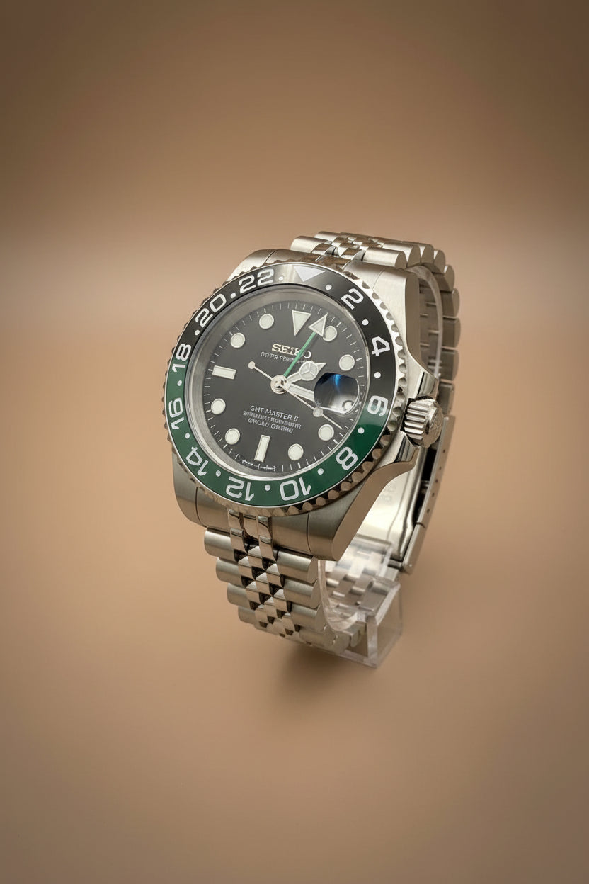 Watch with green and black bezel on a dark background