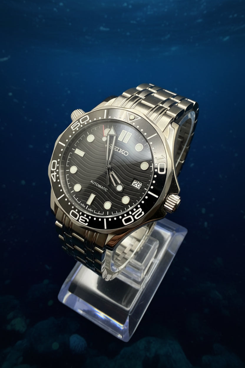 Wristwatch with black dial and silver metal band on a dark background