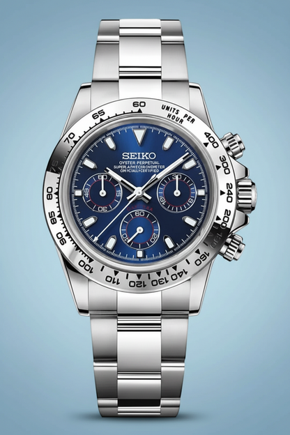 A Seiko wristwatch with a silver stainless steel bracelet and case, featuring a deep blue dial with three subdials and a black tachymeter bezel, shown against a solid black background.
