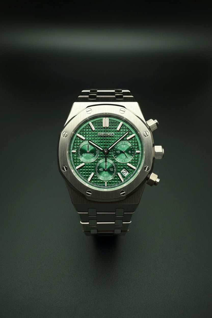 A Seiko wristwatch with a silver-tone metal case and bracelet, featuring a textured green dial with three subdials and green accents.