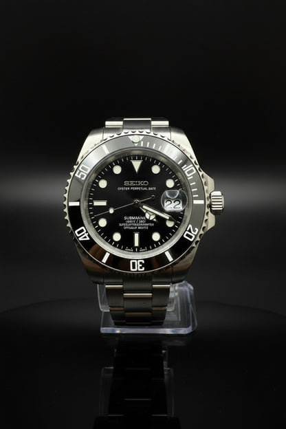 A Seiko Submariner Date watch with a black dial, black bezel, and a silver stainless steel case and bracelet, displayed on a dark gray background.