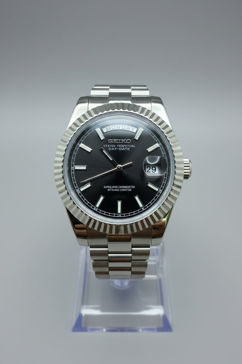 Silver watch with a black face on a dark gray background