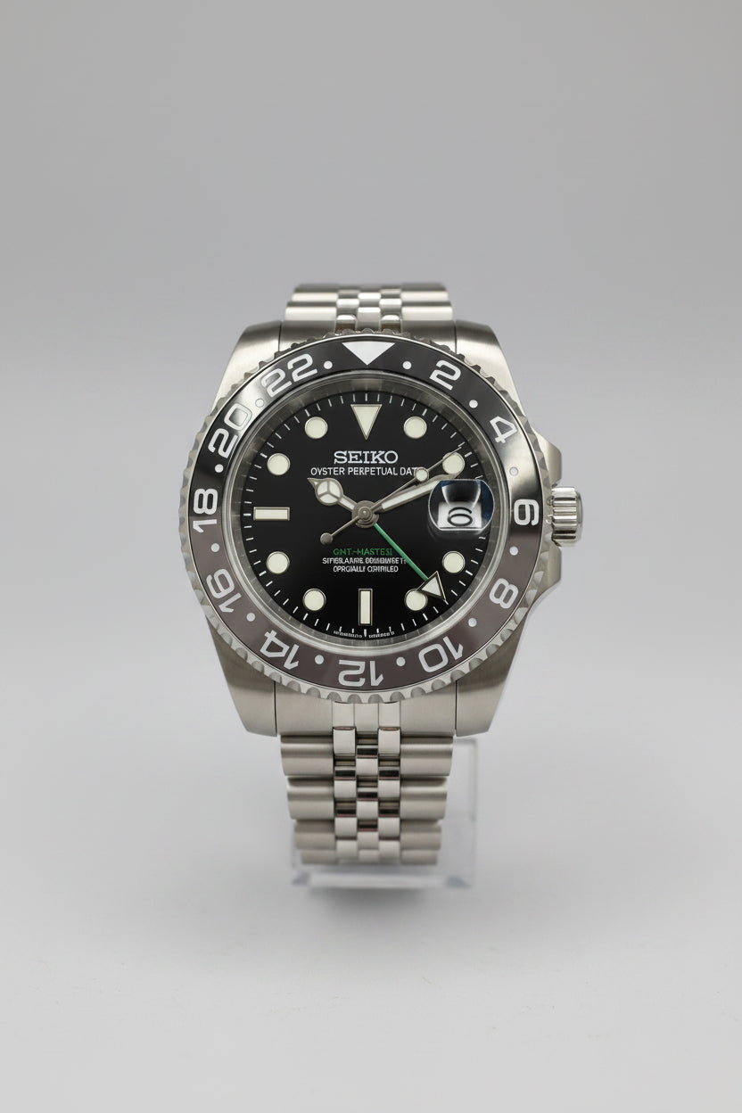 A Seiko Prospex dive watch with a stainless steel case, black dial, and a black-and-white ceramic bezel, displayed on a dark background.