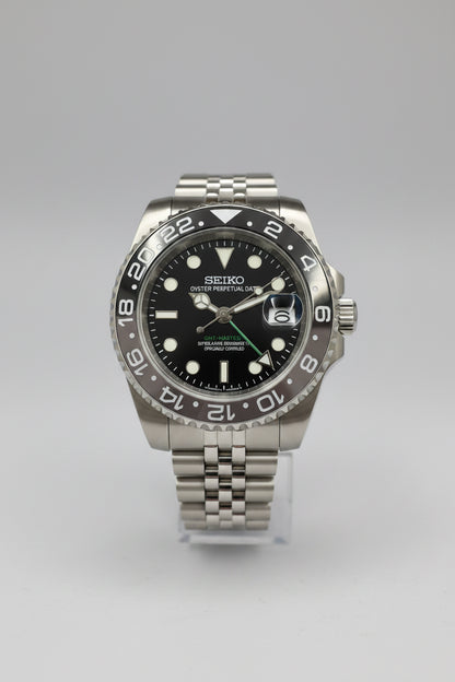 A Seiko Prospex dive watch with a stainless steel case, black dial, and a black-and-white ceramic bezel, displayed on a dark background.