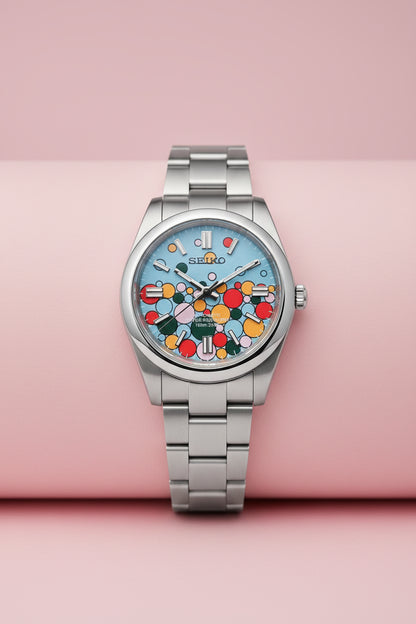 A Seiko stainless steel wristwatch with a colorful floral dial pattern on a black background.