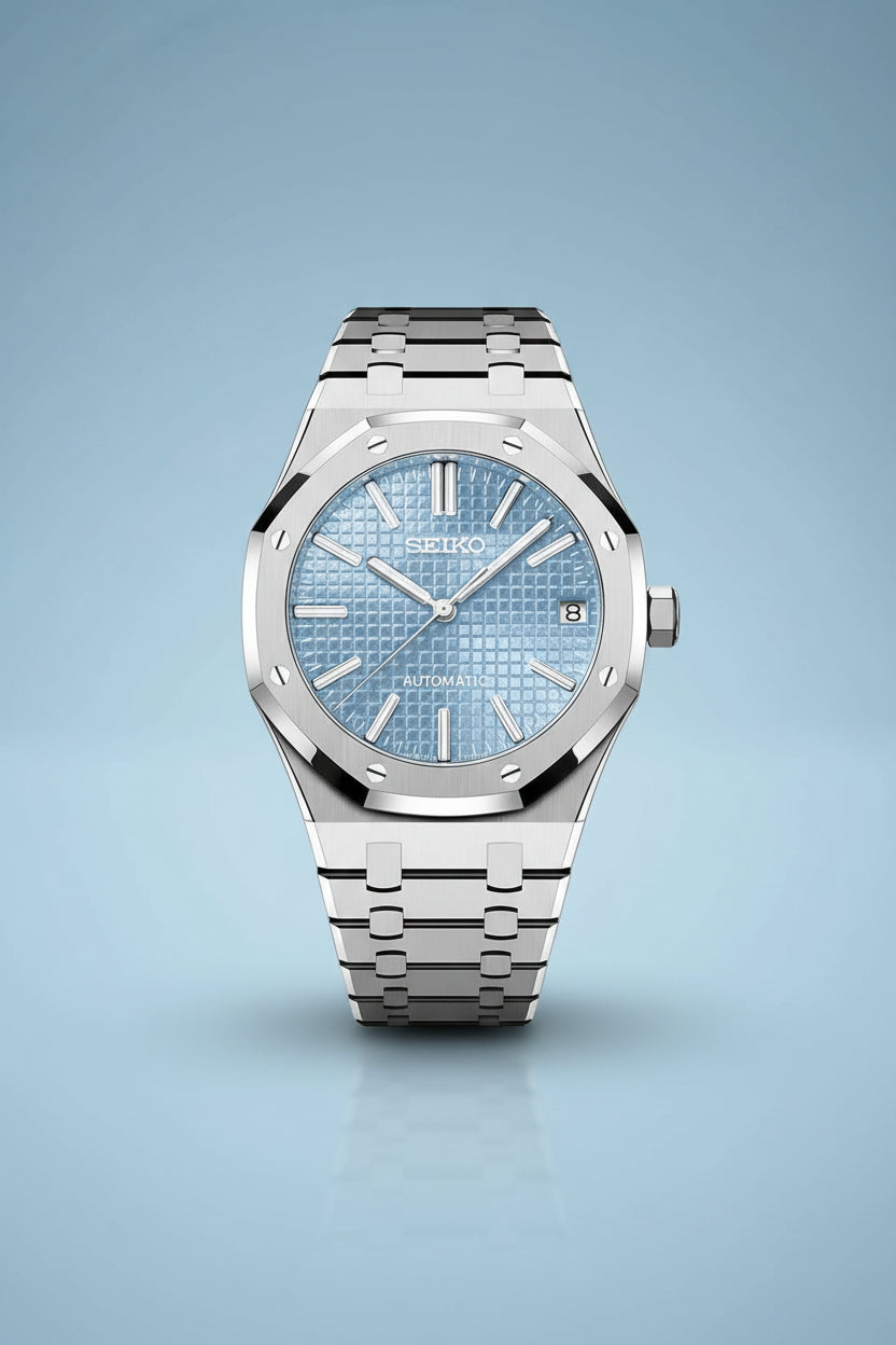 Seiko watch with blue face and silver metal strap on a black background