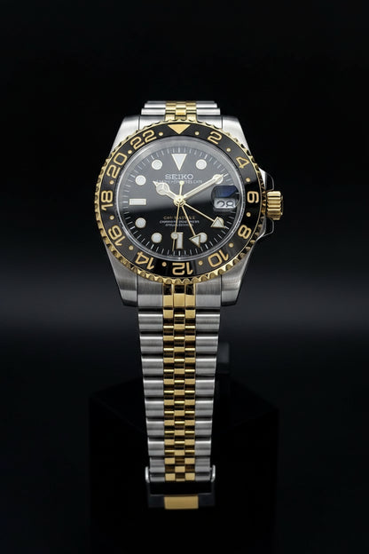 Seiko watch with two-tone metal strap on a gray background
