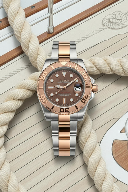 Two-tone watch with brown and gold face on a light gray background